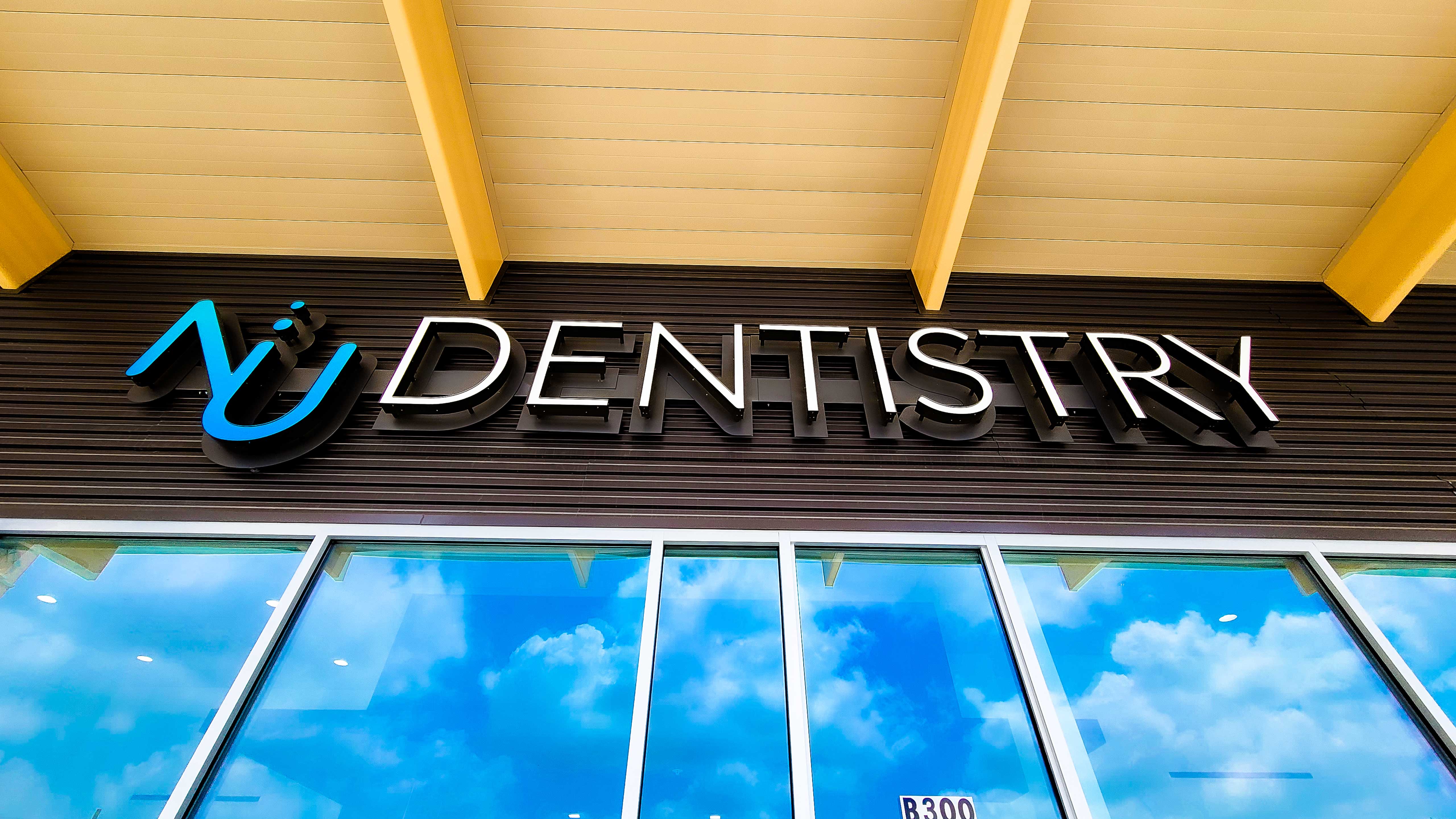 Nu Dentistry logo on a sign outside the office.
