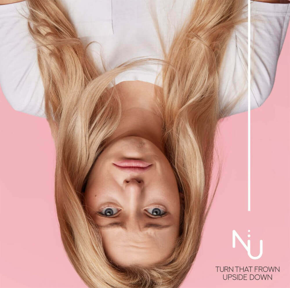 An upside-down picture of a woman with a sad expression.