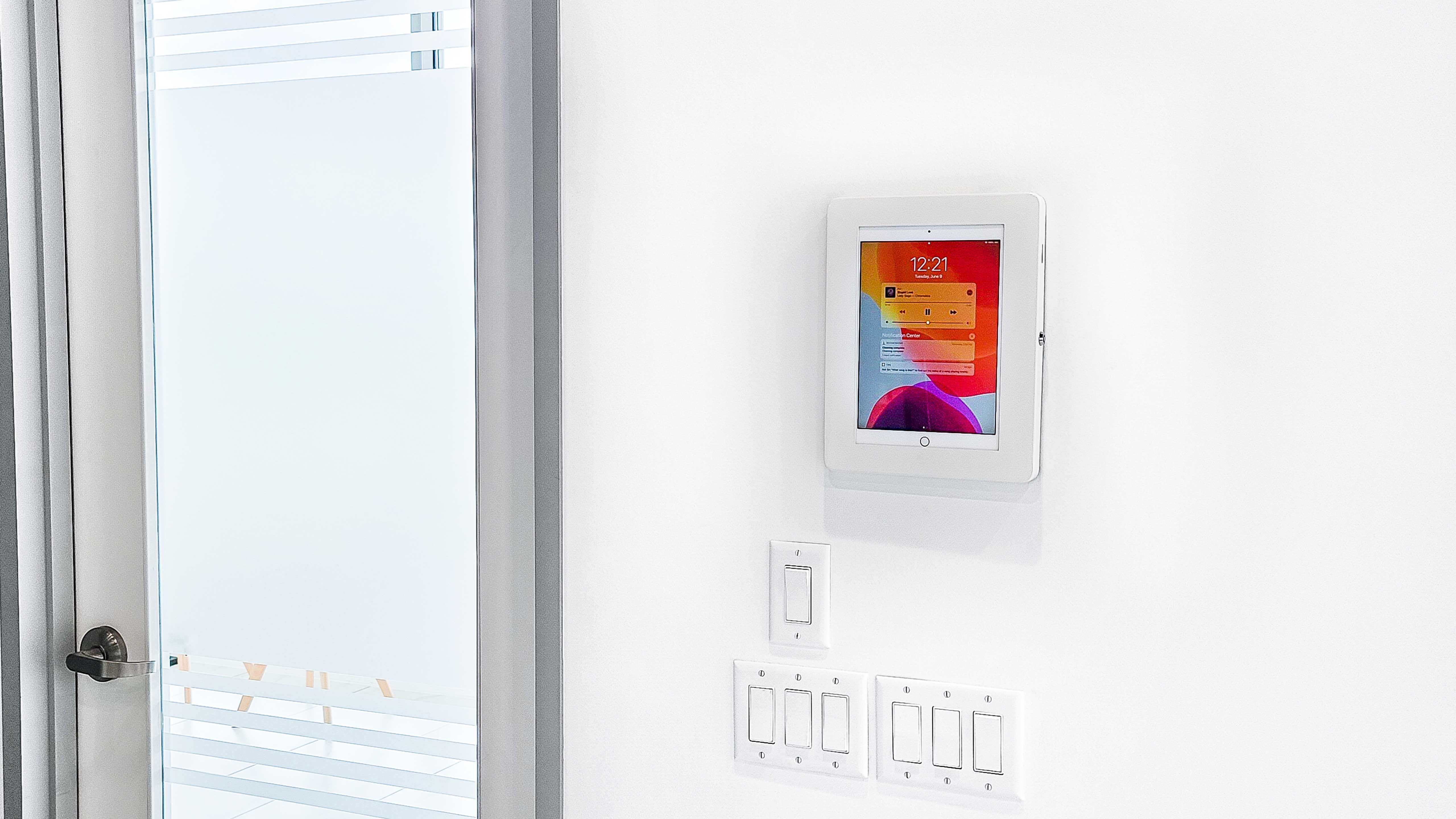 A tablet embedded in the wall beside the door.